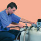 Image of a British gas engineer flushing a radiator